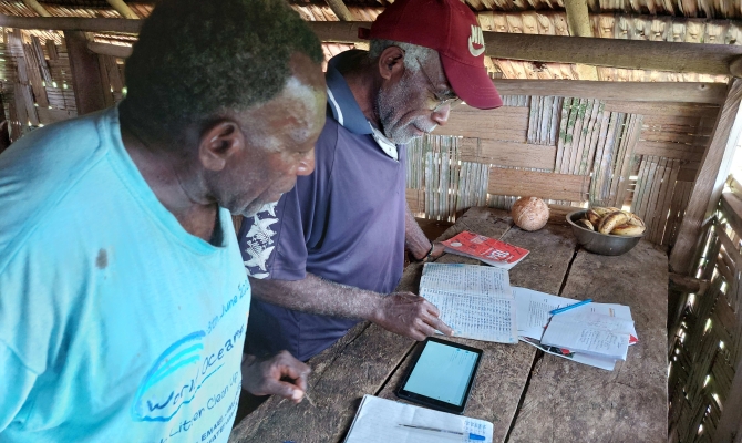 Noel Kaibaba and Philip Vanuau of Bamboo Bay, Malekula are entering turtle nest data into a new online smart-phone data collection app as part of the By-catch and Integrated Ecosystem Management (BIEM) Initiative in Vanuatu. Image Credit: Christopher Bartlett, Resilience